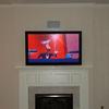 TV over fireplace with recessed speakers...